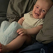 Benjamin is registered to the contest to win money with this photo: baby, smiling, infant, blanket, pillow, bed, cozy, happy, child, cute, skin, hand, foot, clothing, indoors, portrait, relaxing, comfort, young, person