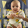Adam participe au concours pour gagner de l'argent avec cette photo : baby, infant, child, person, hands, legs, socks, clothing, lemon_print, banner, decoration, party, celebration, blue_background, gold_pennants, cute, portrait, holding, indoor, smiling