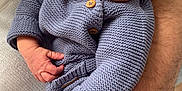 Adam participe au concours pour gagner de l'argent avec cette photo : baby, sleeping, knitted_clothing, blue_hat, blue_outfit, infant, adult_arm, watch, white_sweater, close_up, peaceful, cozy, hand, portrait, indoor, skin, cute, newborn, resting, tender_moment