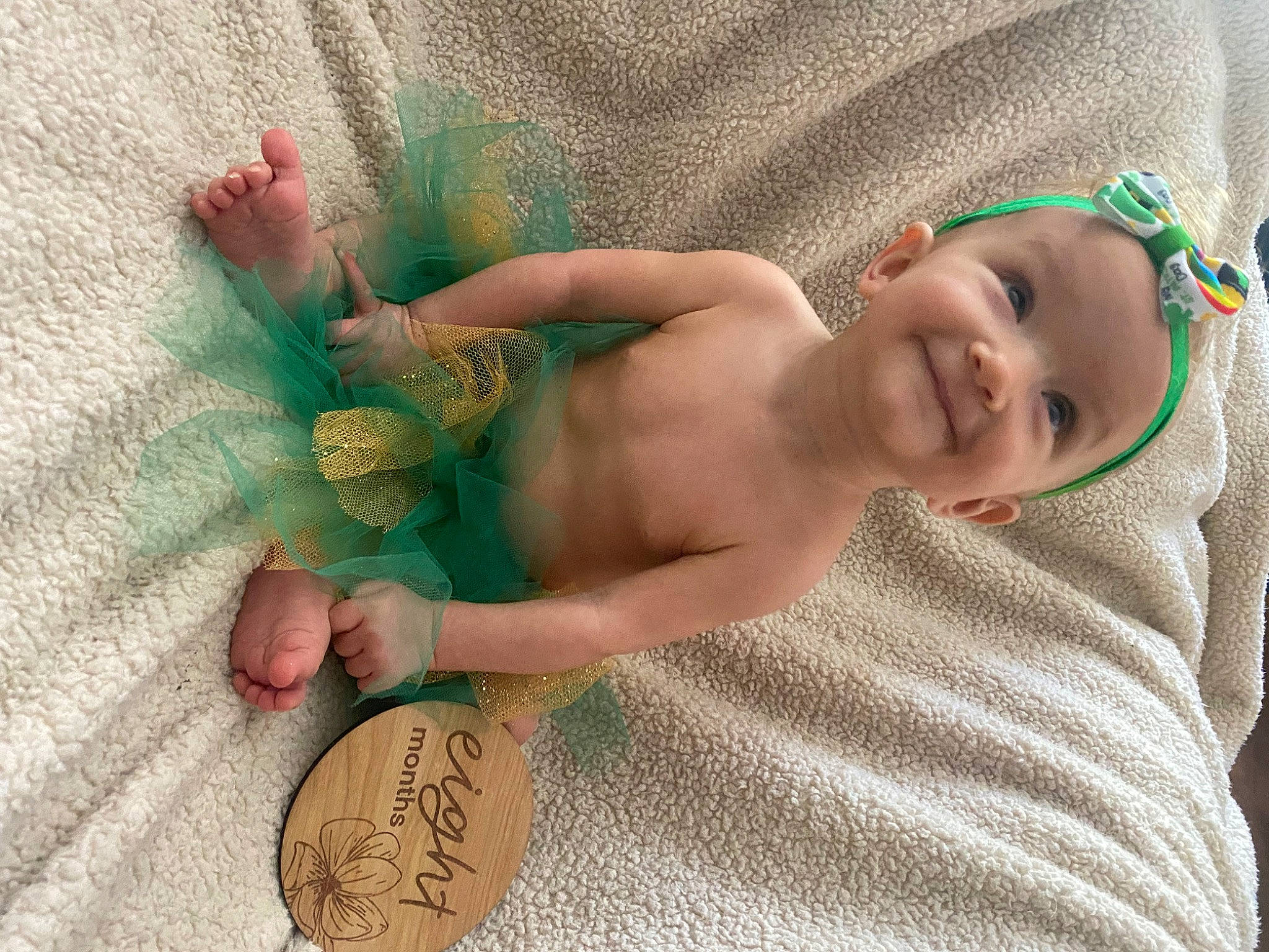 Coraline is registered to the contest to win money with this photo: abdomen, baby, baby_toddler_clothing, child, comfort, finger, fun, grass, happy, human, joy, linens, pattern, people_in_nature, person, skin, smile, textile, thumb, toddler