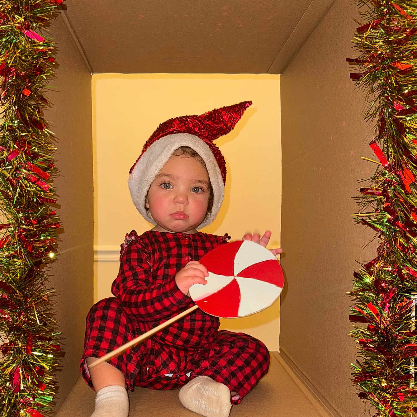 Ava joined the competition — help win amazing prizes! architecture, baby, building, cap, clothing, costume, face, hat, head, hood, hosiery, outdoors, person, photography, plant, portrait, pottedplant, shelter, sock, tree