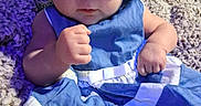 Piper joined the competition — help win amazing prizes! baby, infant, child, portrait, blue_clothing, bonnet, ruffles, dress, sitting, carpet, indoor, face, eyes, hands, serious_expression, centered_composition, close_up, colorful, soft_fabric, family_photo
