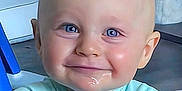 Varek is registered to the contest to win money with this photo: baby, child, blue_eyes, drool, smile, face, indoor, furniture, blue_clothing, head, young_child, cute, expression, sitting, cheeks, person, portrait, skin, happiness, infant