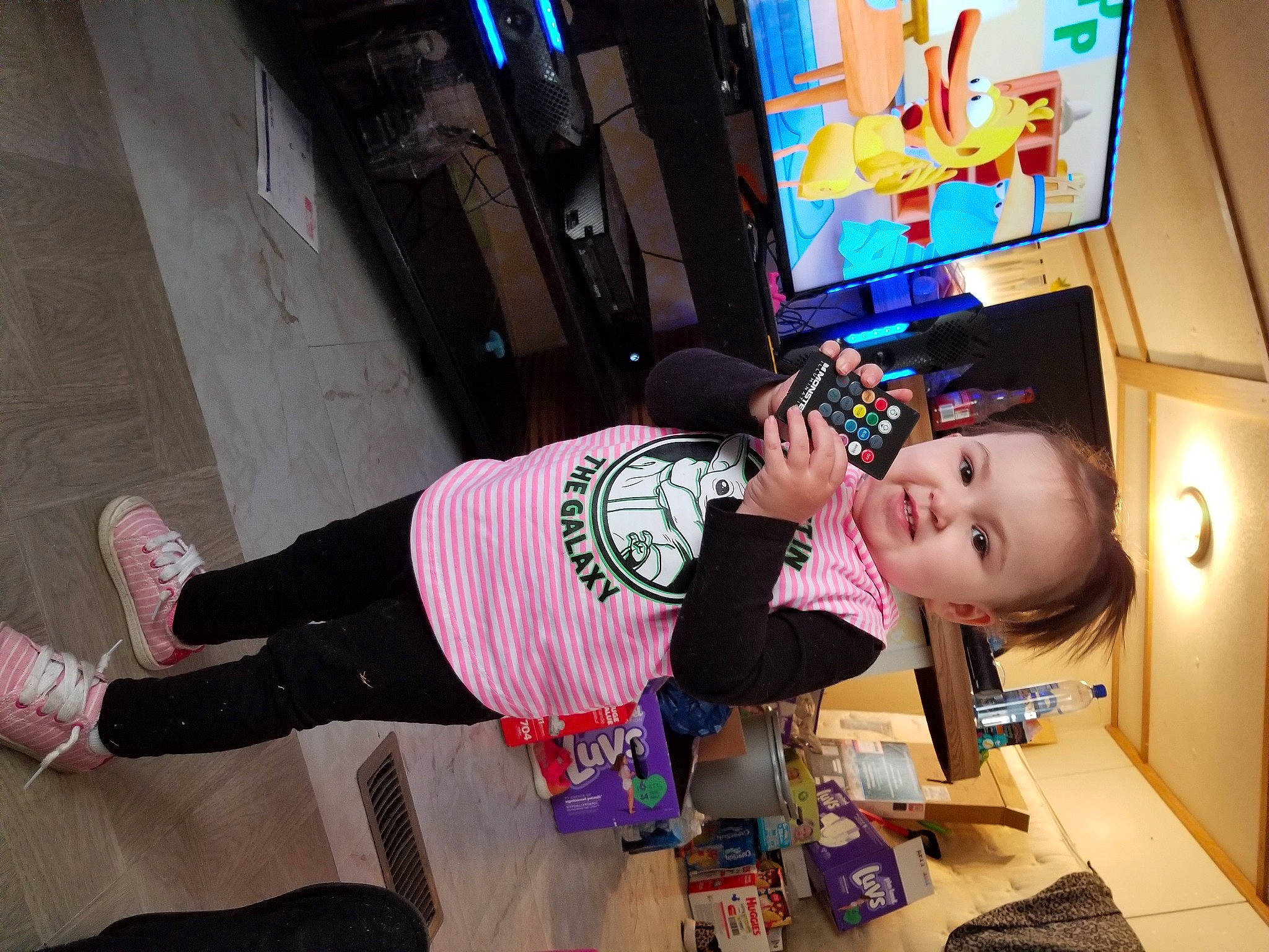 Paige joined the competition — help win amazing prizes! arcade_game, baby, baby_toddler_clothing, display_device, floor, flooring, fun, machine, magenta, pattern, person, purple, room, smile, sock, t_shirt, television, television_set, thigh, toddler