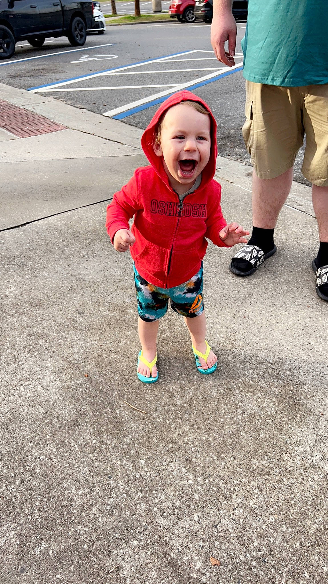 Justin is registered to the contest to win money with this photo: asphalt, baby_toddler_clothing, child, cool, facial_expression, footwear, fun, grass, happy, headwear, leg, leisure, person, plant, recreation, road_surface, shorts, smile, sneakers, t_shirt