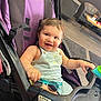 Amir is registered to the contest to win money with this photo: toddler, child, stroller, smile, happy, indoor, sunglasses, purple, seat, clothing, baby, furniture, table, chair, floor, wooden_floor, playful, cute, person, young_child