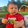 child, toddler, baby, red_shirt, flowers, outdoor, daylight, greenery, bench, park, person, curly_hair, holding, nature, sunlight, casual_clothing, cute, skin, portrait, summer