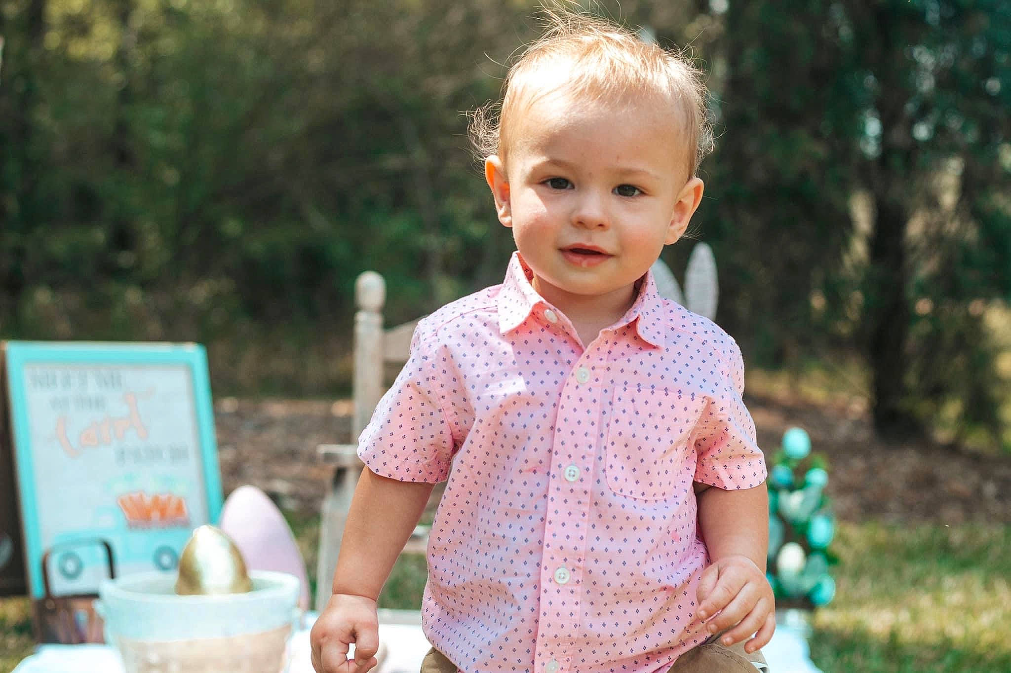 Cooper is registered to the contest to win money with this photo: baby, bowl, child, cup, event, grass, happy, leisure, pattern, people_in_nature, person, plaid, plant, recreation, sitting, smile, summer, t_shirt, tableware, toddler