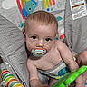 baby, pacifier, toy, baby_chair, rainbow, sun, monkey, elephant, floor, infant, child, colorful, playtime, cute, indoors, seat, striped, striped_toy, looking_up, young