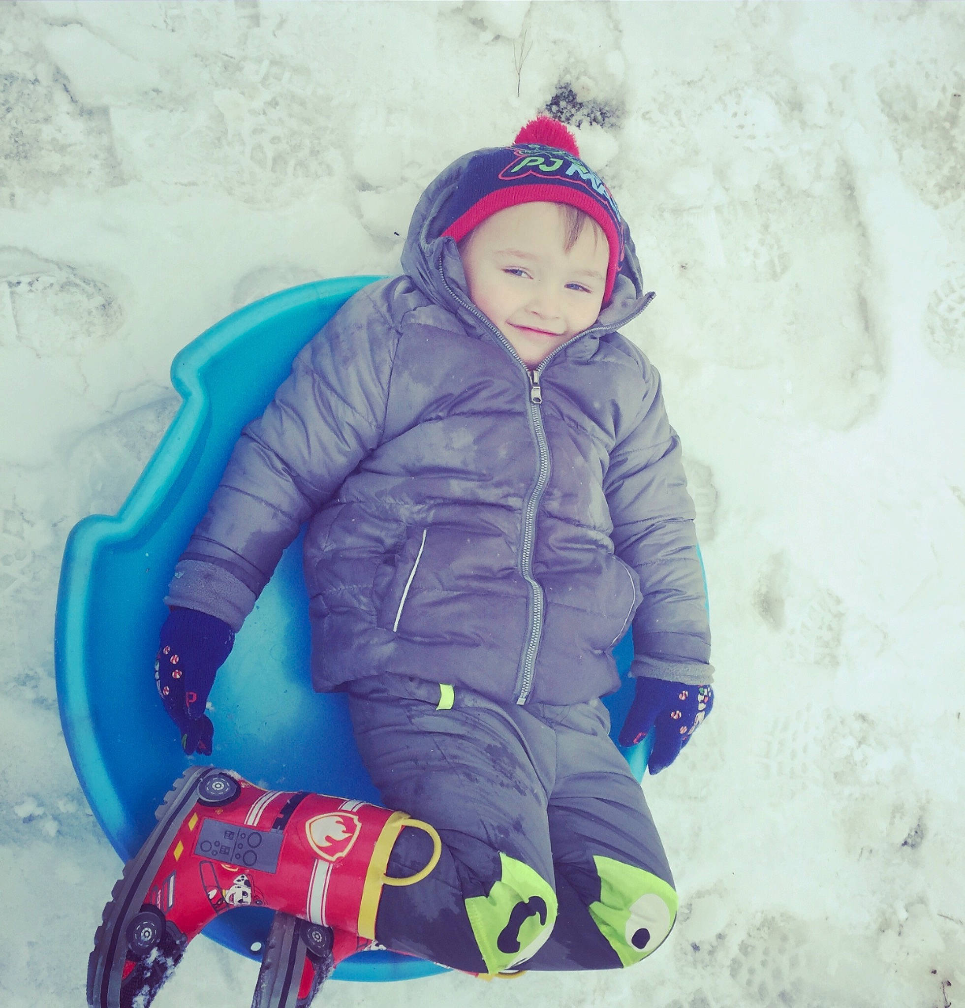 Dayton is registered to the contest to win money with this photo: blizzard, child, cool, freezing, fun, hood, jacket, outerwear, person, play, playing_in_the_snow, recreation, snow, toddler, winter, winter_storm