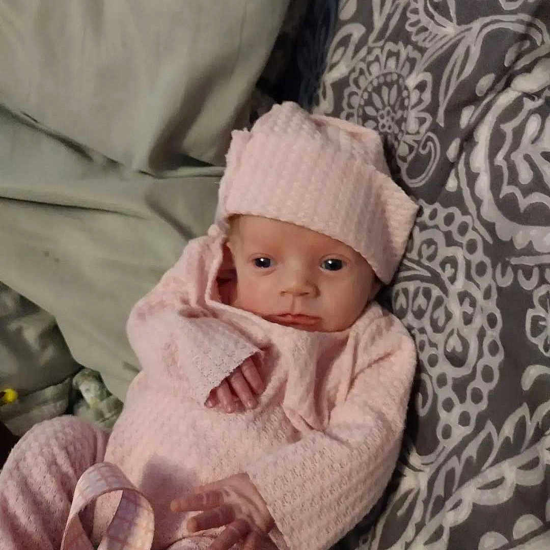 Sophia joined the competition — help win amazing prizes! baby, blanket, bonnet, cap, clothing, cushion, face, happy, hat, head, homedecor, newborn, person, photography, portrait, quilt, sitting, sleeping, smile, tape