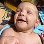 Aurora is registered to the contest to win money with this photo: baby, smiling, face, skin, tattoo, arm, towel, blue, hand, infant, happy, closeup, child, person, indoor, light, expression, cute, young, portrait