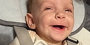 Aurora is registered to the contest to win money with this photo: baby, smiling, blanket, infant, seatbelt, happy, child, face, cushion, clothing, indoor, portrait, young, cute, expression, baby_boy, head, skin, closeup, comfort