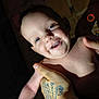 Aurora is registered to the contest to win money with this photo: baby, child, smile, drool, tattoo, hand, skin, blue_eyes, indoor, portrait, happy, person, infant, cute, expression, face, holding, light, shadow, background