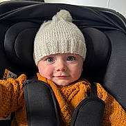 Nolan a rejoint le concours — aidez-le/la à gagner de superbes lots ! baby, baby_carrier, blue_eyes, bundledup, car_seat, child, closeup, clothing, cute, harness, hat, indoors, infant, knit_hat, orange_sweater, pom_pom, portrait, seat_strap, smile, wide_eyes