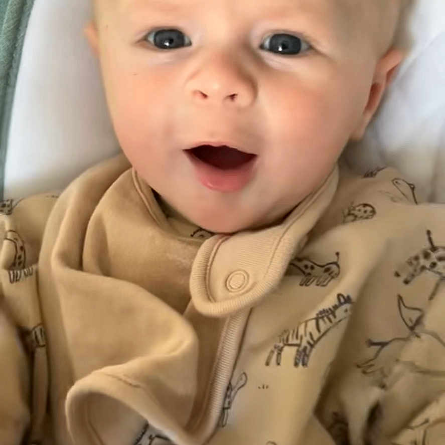 Lenny is registered to the contest to win money with this photo: animal_prints, baby, child, closeup, clothing, comfort, cushion, cute, expression, eyes, face, head, indoor, infant, mouth_open, portrait, sitting, skin, soft_tones, young