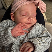 Aryah joined the competition — help win amazing prizes! baby, sleeping, hand, headband, pink, bow, sweater, knitwear, cozy, cute, child, infant, peaceful, face, closed_eyes, couch, indoors, portrait, soft, relaxation