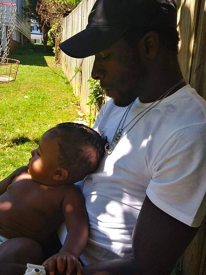 Kingston is registered to the contest to win money with this photo: adaptation, baby, black, black_hair, child, hand, people, person, toddler, tree