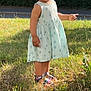 Zeyna participe au concours pour gagner de l'argent avec cette photo : toddler, child, dress, hat, outdoor, grass, sunlight, pointing, sandals, summer, nature, greenery, flower, pinecone, curious, person, young_child, casual_clothing, daytime, expression