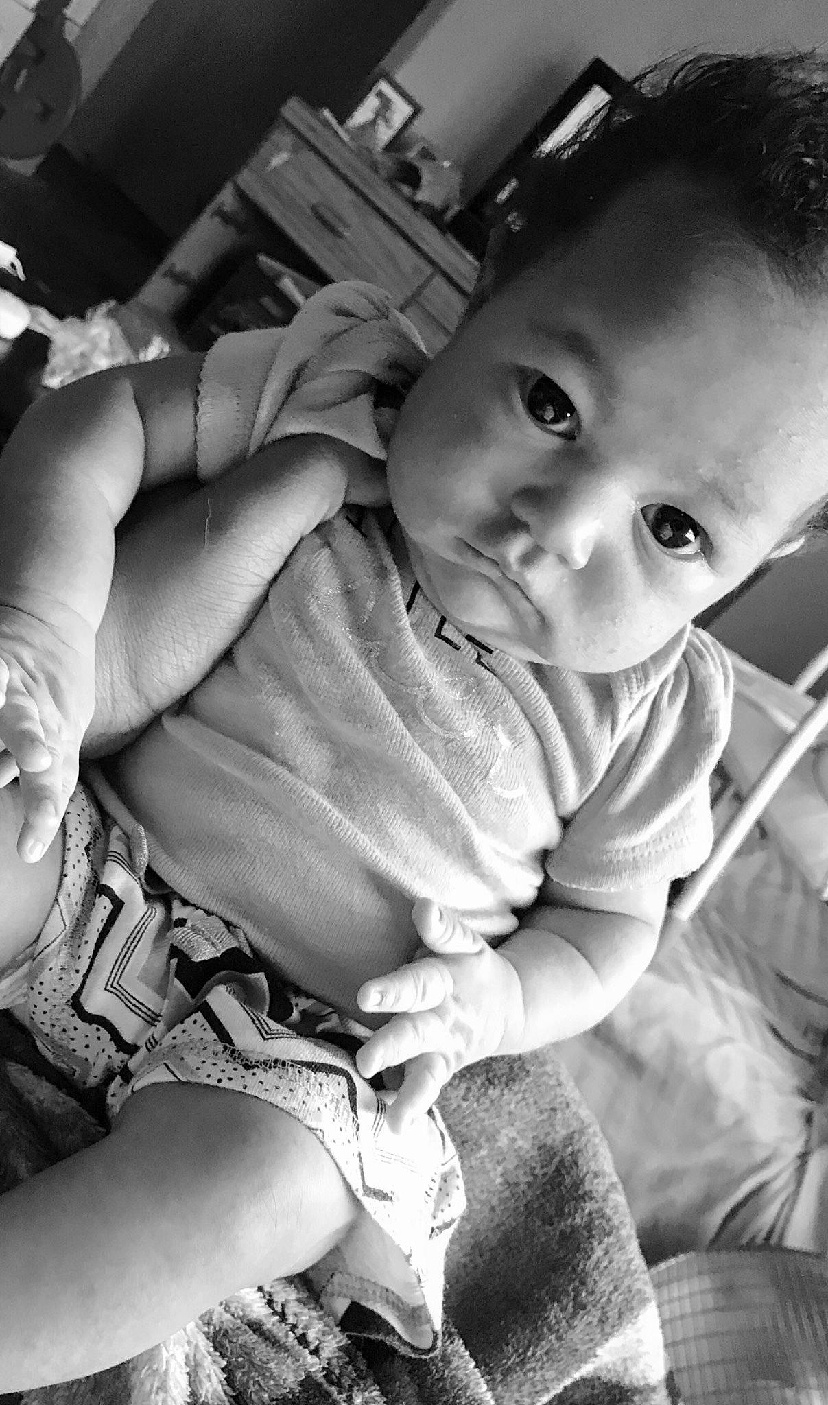 Zahara is registered to the contest to win money with this photo: baby, black, black_and_white, cheek, comfort, flash_photography, hand, happy, head, human, human_body, iris, leg, mammal, mouth, nose, organ, person, skin, smile