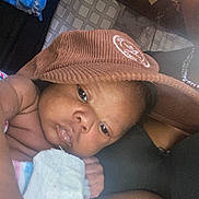 Antonio Jr is registered to the contest to win money with this photo: baby, infant, hat, blanket, closeup, face, skin, child, sleepy, resting, corduroy, soft_toy, indoor, person, newborn, portrait, hand, cute, relaxing, comfort