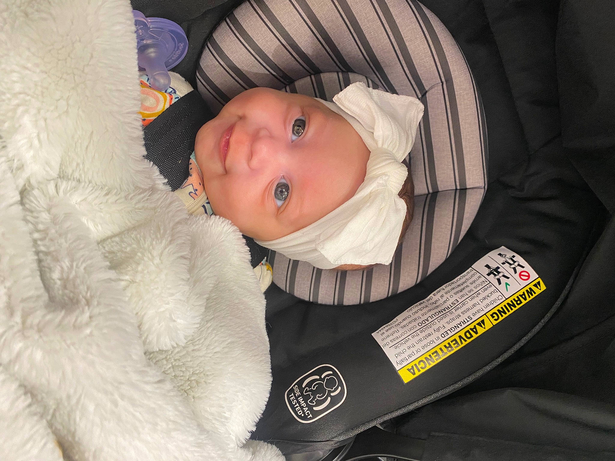 Denali is registered to the contest to win money with this photo: baby, baby_carriage, baby_products, baby_safety, baby_sleeping, baby_toddler_clothing, cheek, child, comfort, eye, fur, head, headwear, infant_bed, linens, person, room, sitting, sleeve, smile