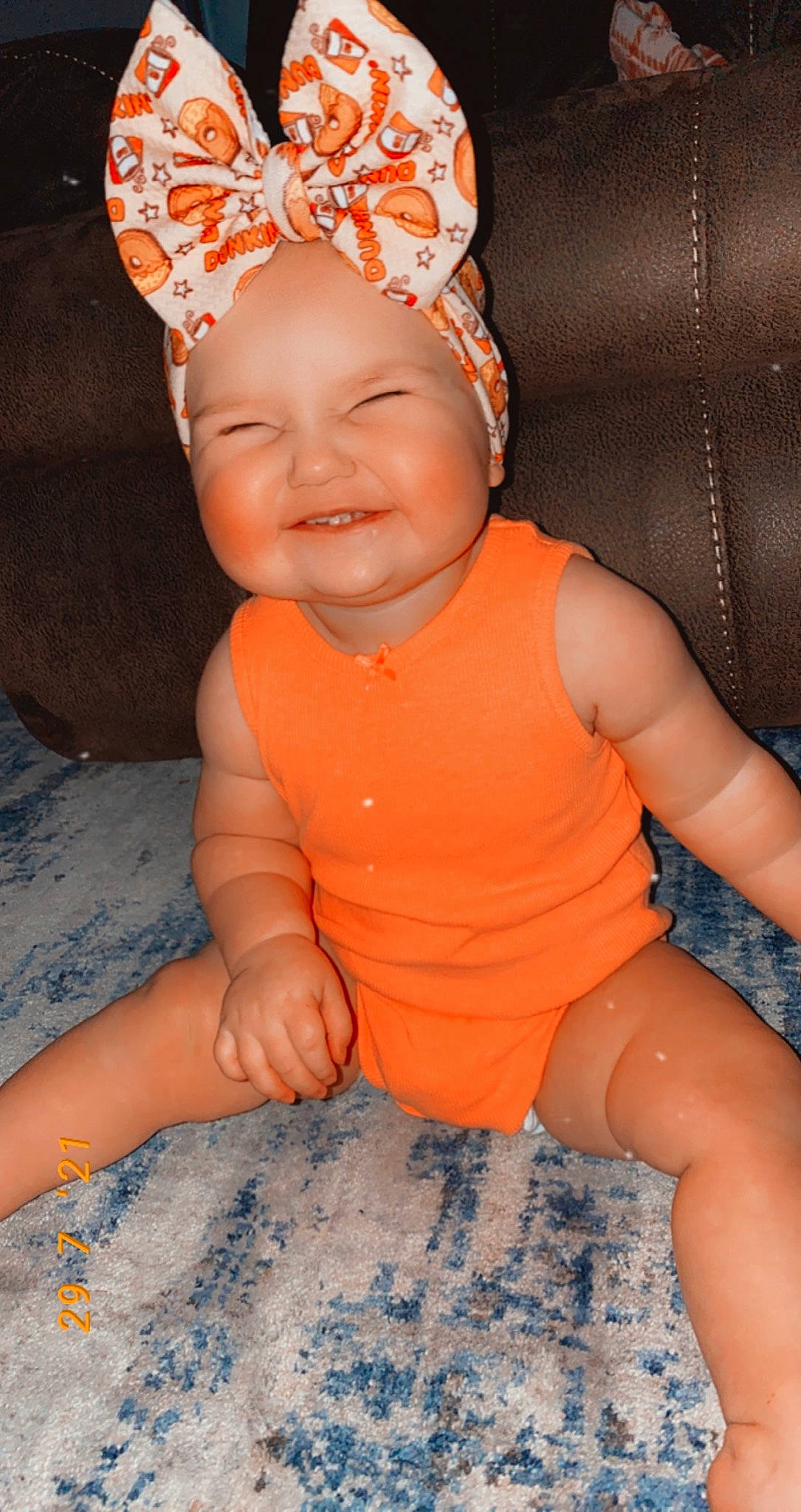 Jade is registered to the contest to win money with this photo: baby_toddler_clothing, cap, chin, dress, eye, face, finger, happy, head, headwear, human_body, iris, joy, lip, mouth, orange, person, pink, skin, sleeve