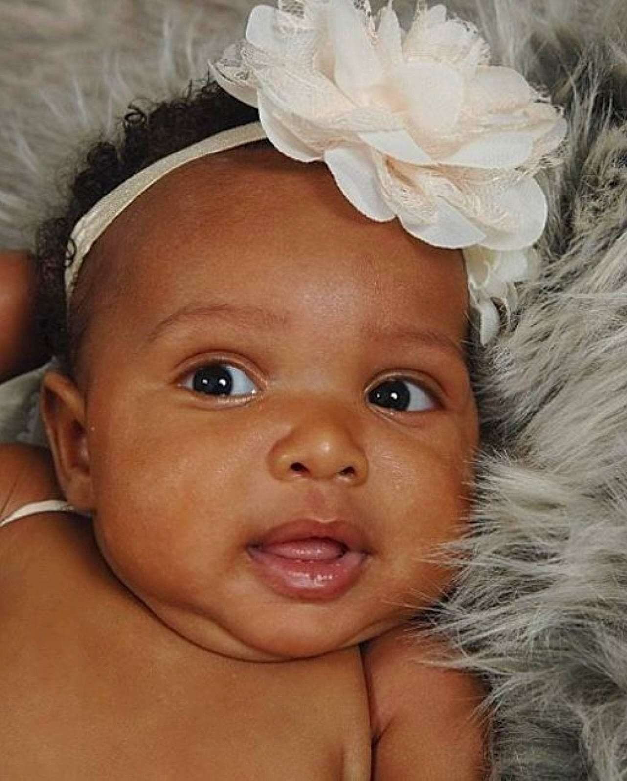 Amani joined the competition — help win amazing prizes! cheek, chin, ear, eyebrow, eyelash, face, flash_photography, flower, forehead, happy, headgear, iris, lip, nose, organ, person, petal, skin, smile, toddler