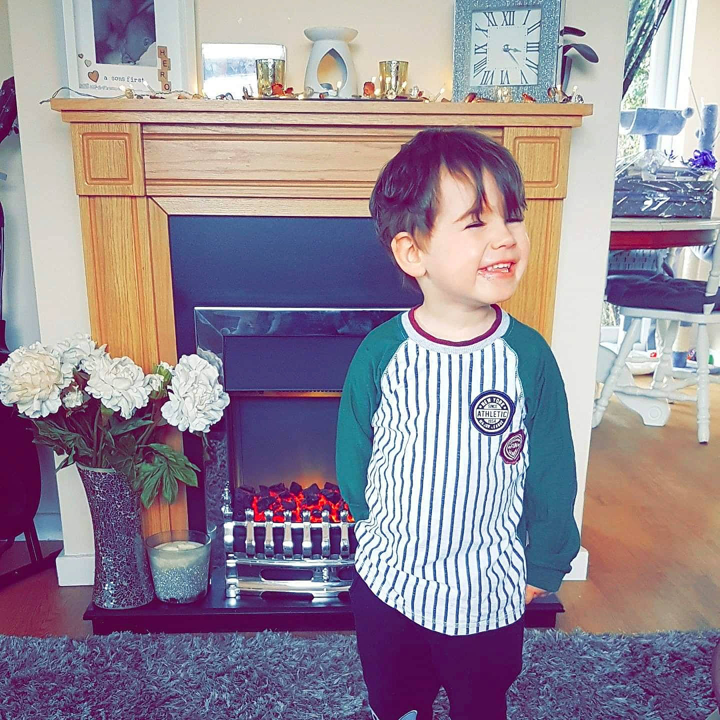 Spencer joined the competition — help win amazing prizes! black, blue, child, electric_blue, flower, flower_arranging, happy, holiday, living_room, person, picture_frame, plant, room, sitting, sleeve, smile, standing, t_shirt, textile, toddler