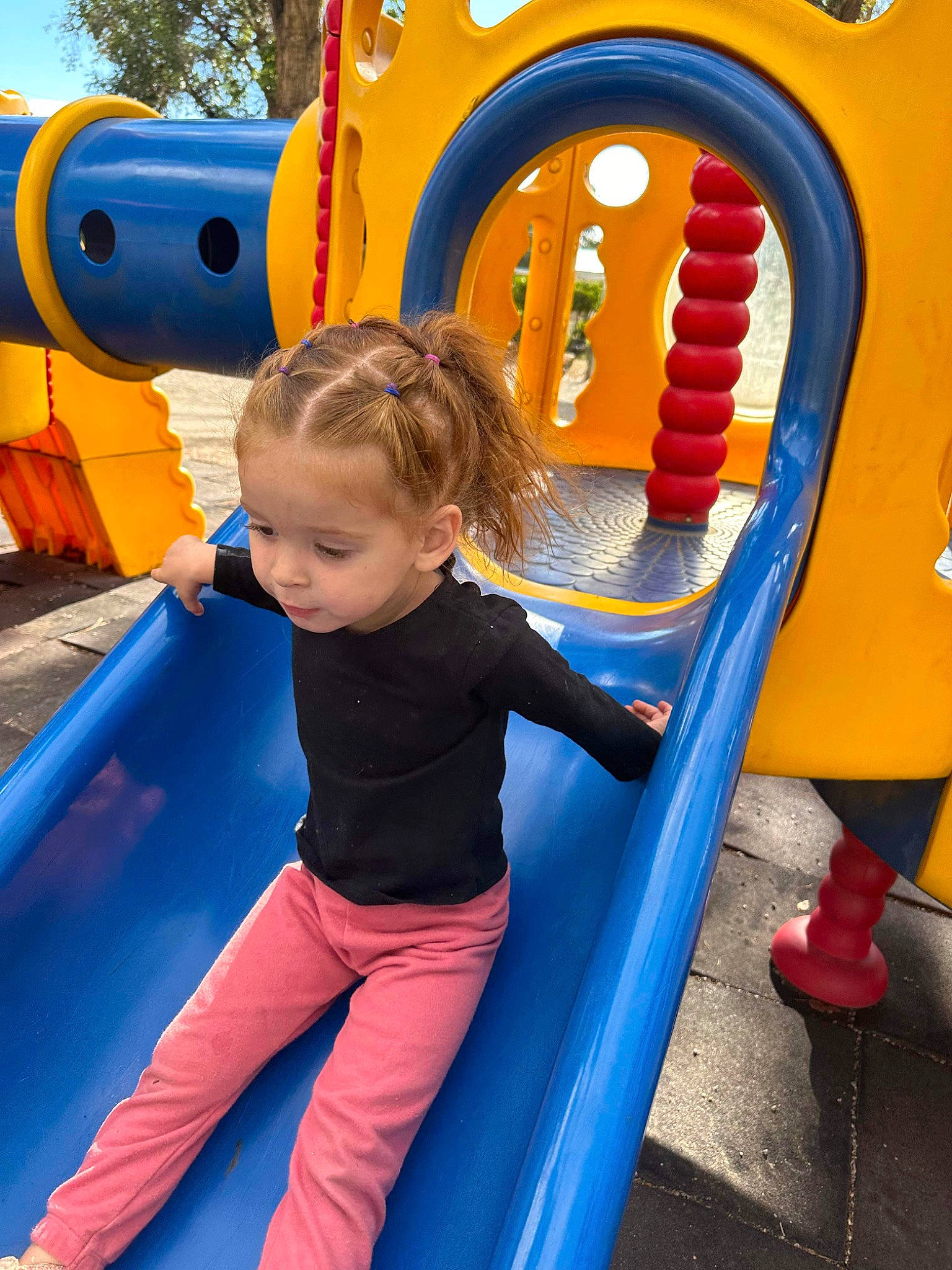 Malia joined the competition — help win amazing prizes! blue, child, chute, city, clothing, fun, leisure, organ, outdoor_play_equipment, outdoor_recreation, person, photograph, playground, playground_slide, product, recreation, smile, snapshot, summer, toddler