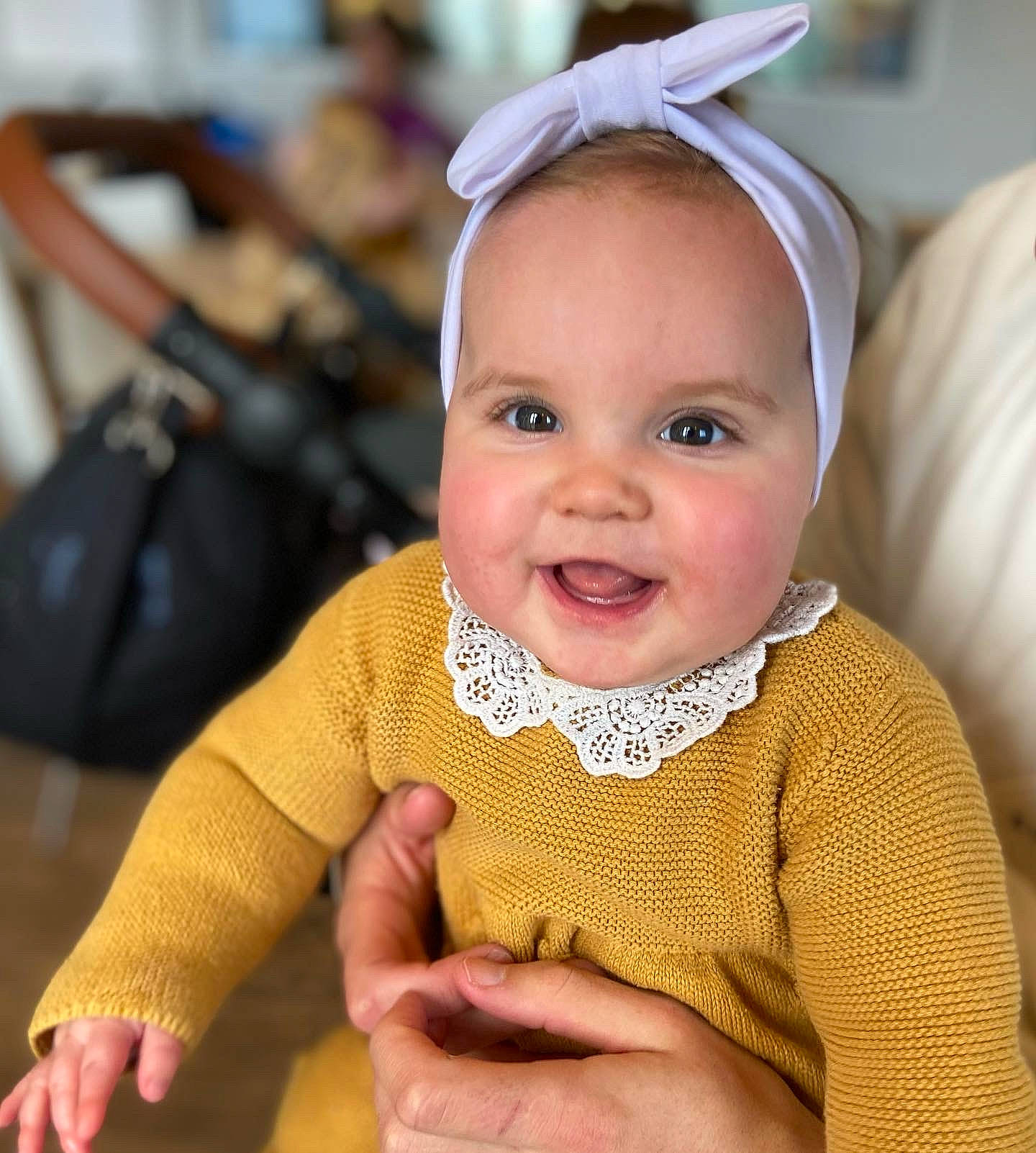 Darcie is registered to the contest to win money with this photo: baby, baby_toddler_clothing, child, eye, eyelash, fun, happy, head, iris, joy, luggage_and_bags, nose, outerwear, person, product, skin, sleeve, smile, textile, thumb