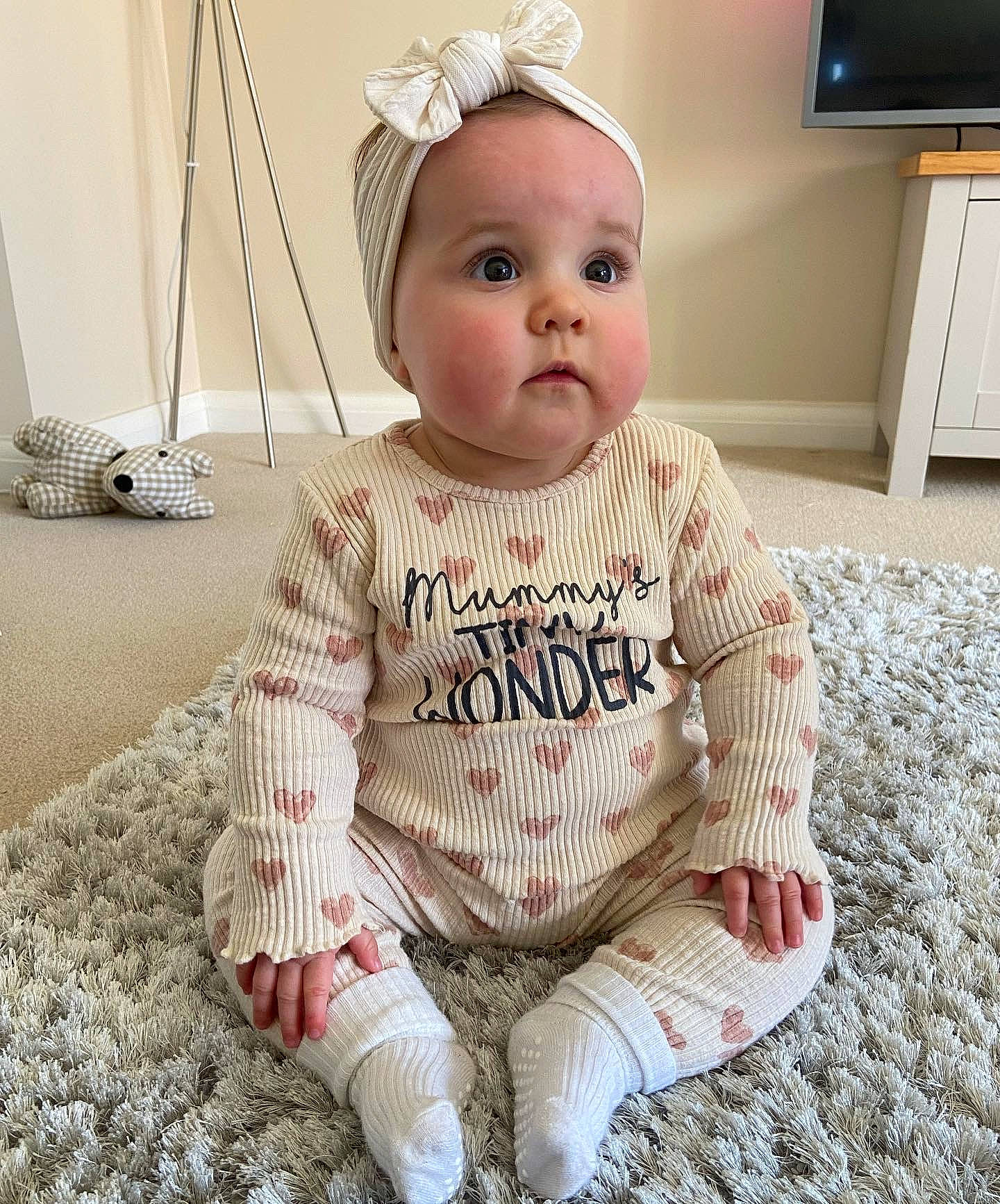 Darcie is registered to the contest to win money with this photo: baby, baby_toddler_clothing, cap, child, fashion_accessory, flooring, happy, headband, home_appliance, knit_cap, led_backlit_lcd_display, lip, person, skin, sleeve, surprise, t_shirt, television, television_set, toddler