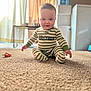 Elliott is registered to the contest to win money with this photo: baby, child, pajamas, striped_clothing, carpet, indoor, smiling, sitting, cute, person, floor, playtime, home, curtains, natural_light, young_child, infant, happy, portrait, cozy