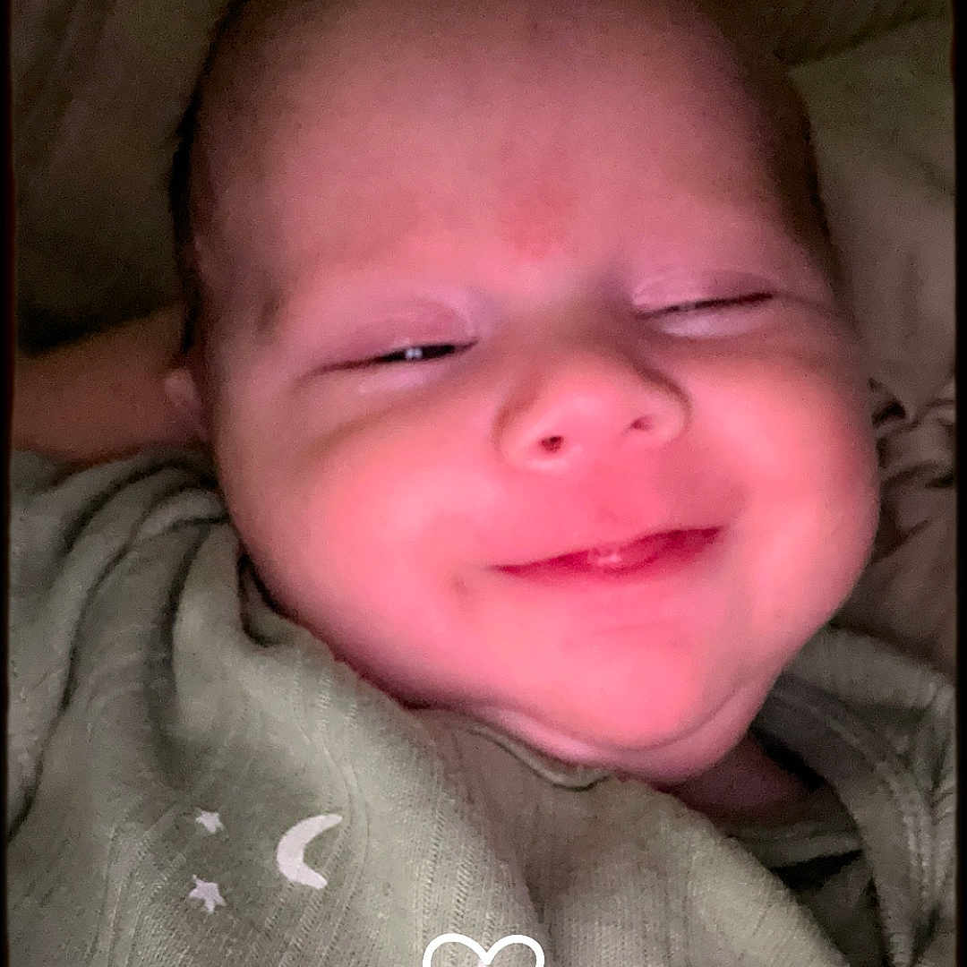 Cooper Max is registered to the contest to win money with this photo: accessories, baby, bodypart, cushion, earring, face, happy, head, homedecor, jewelry, laughing, mouth, newborn, person, photography, portrait, quilt, selfie, sleeping, smile