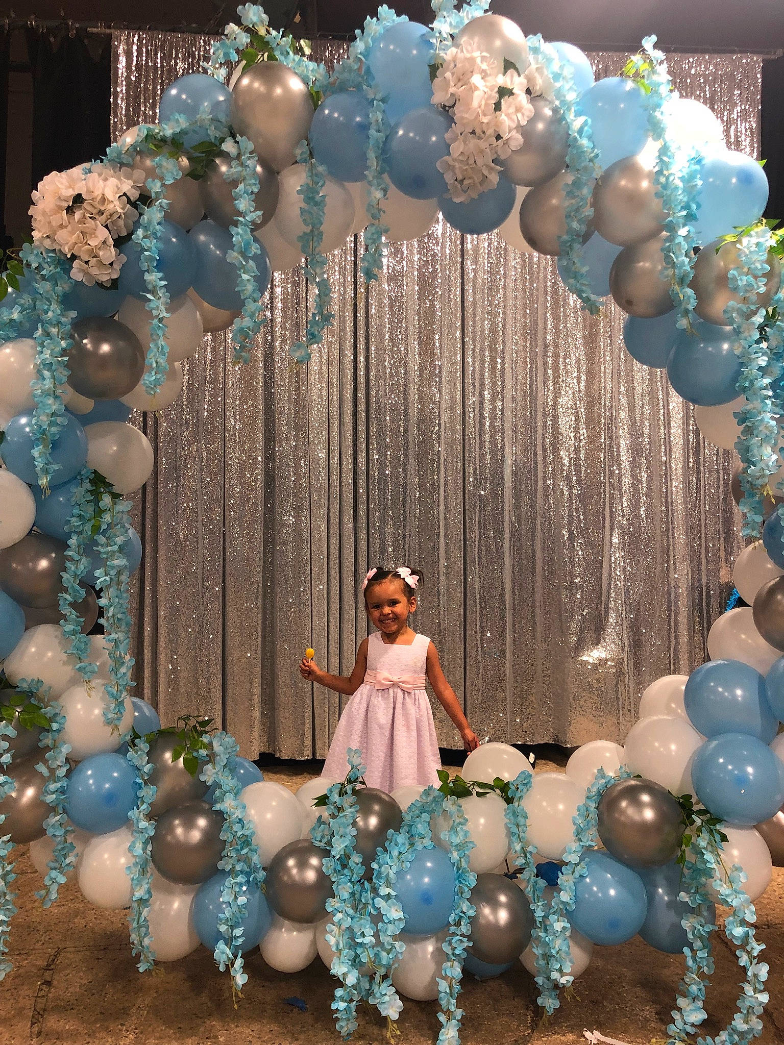Hayley is registered to the contest to win money with this photo: aqua, arch, architecture, balloon, blue, ceremony, decoration, event, interior_design, joy, party, party_supply, person, tree, turquoise