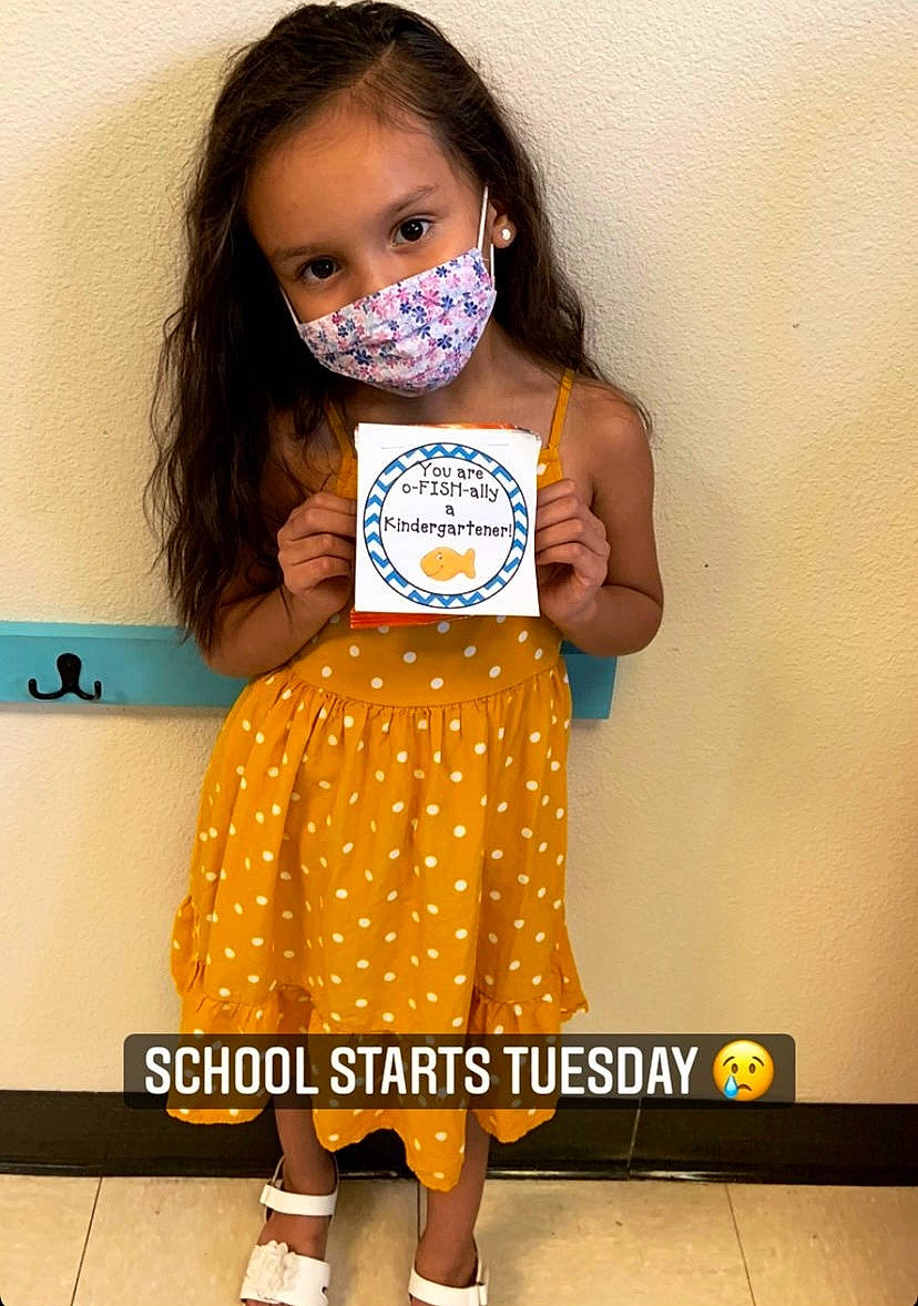 Hayley is registered to the contest to win money with this photo: baby_toddler_clothing, clothing, cool, dress, eyelash, facial_expression, fashion_design, finger, hairstyle, happy, neck, orange, person, pink, shoulder, sleeve, standing, street_fashion, t_shirt, textile