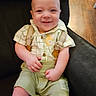 baby, baby_fashion, chair, checkered_shirt, child, clothing, cute, face, green_shorts, happy, indoor, infant, one_person, person, portrait, seated, skin, smile, suspenders, wooden_floor