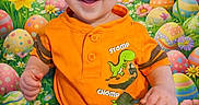 Nathan joined the competition — help win amazing prizes! baby, background, basket, bunny, celebration, child, colorful, cute, dinosaur_graphic, easter_eggs, festive, flowers, happy, holiday, indoor, orange_shirt, playful, portrait, shorts, smiling