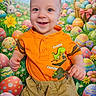 Nathan joined the competition — help win amazing prizes! baby, child, smiling, orange_shirt, dinosaur_graphic, shorts, easter_eggs, basket, flowers, bunny, colorful, background, happy, portrait, playful, indoor, celebration, cute, holiday, festive