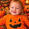 Nathan is registered to the contest to win money with this photo: autumn, baby, candle, child, close_up, costume, fall_leaves, halloween, happy, harvest, infant, jack_o_lantern, lantern, orange_clothing, outdoor_style, portrait, pumpkin, seasonal_decor, smiling, straw