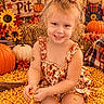 Paisley is registered to the contest to win money with this photo: child, girl, toddler, smiling, portrait, autumn, fall, corn, corn_pit, pumpkins, sunflowers, scarecrow, hay_bale, harvest, outdoor, rustic, floral_bow, dress, orange, seasonal_decor