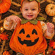 Isabella joined the competition — help win amazing prizes! autumn, baby, child, costume, decorations, fairy_lights, fall, festive, halloween, happy, headband, indoor, infant, leaves, orange, portrait, pumpkin_costume, pumpkins, smiling, striped_leggings