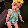 Isabella is registered to the contest to win money with this photo: baby, casual, child, colorful_clothing, couch, curious, cute, face, happy, headband, indoor, infant, legs, portrait, romper, sitting, small_hands, soft_skin, yellow_bow, young_child