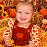 Isabella joined the competition — help win amazing prizes! autumn, baby, bow, child, colorful, corn, corn_pit, fall, happy, harvest, orange, outdoor, overalls, portrait, pumpkin, scarecrow, seasonal, smiling, sunflowers, toddler