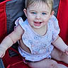 Isabella is registered to the contest to win money with this photo: arm, baby, blue_eyes, child, cushion, cute, face, floral_pattern, hair, happy, infant, leg, mouth_open, outdoor, person, pink_clothing, red_chair, sitting, skin, smiling