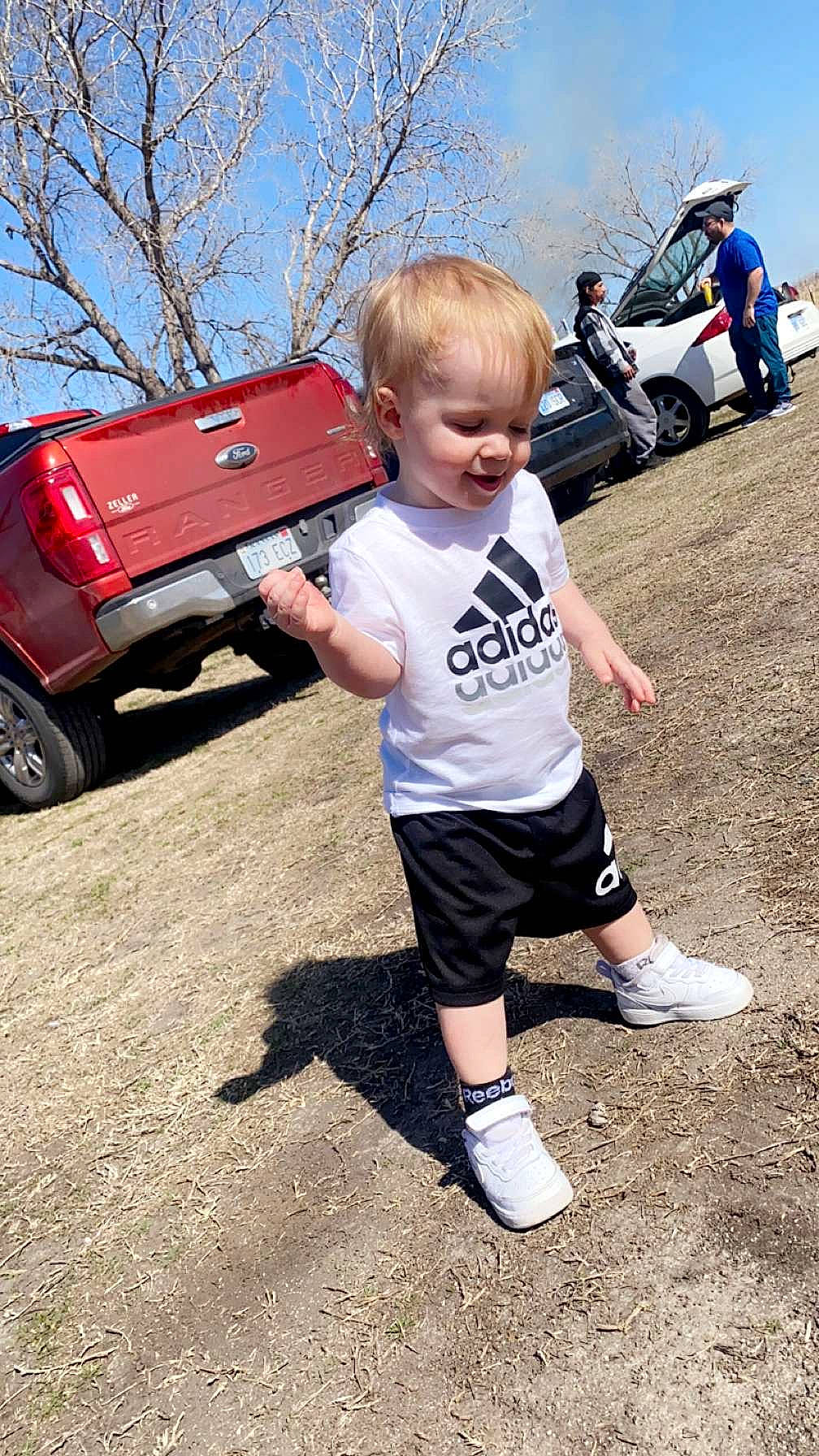 Blake joined the competition — help win amazing prizes! asphalt, automotive_design, automotive_exterior, automotive_tire, bumper, car, fun, leisure, motor_vehicle, person, recreation, shorts, sky, sneakers, t_shirt, tire, toddler, tree, vehicle, vehicle_door