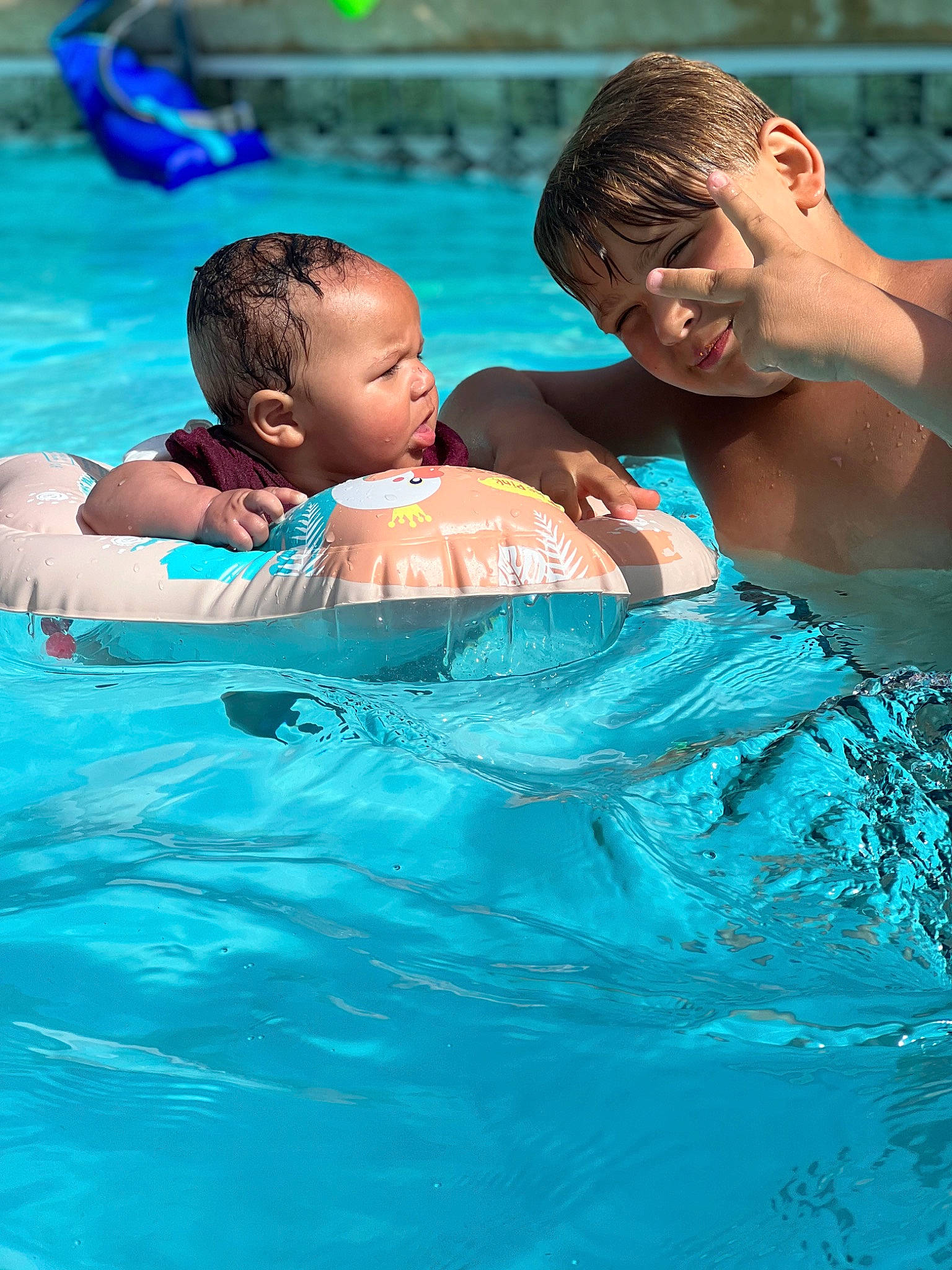 Kyson is registered to the contest to win money with this photo: aqua, azure, baby, bathing, blue, chest, child, face, fluid, fun, games, happy, joy, leisure, leisure_centre, outdoor_recreation, person, pool, recreation, swimming_pool
