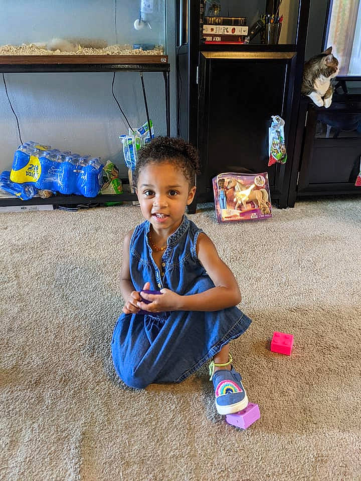 Kya is registered to the contest to win money with this photo: blue, child, electric_blue, floor, flooring, fun, happy, leisure, luggage_and_bags, morning, person, play, public_space, sitting, smile, standing, television, toddler, travel, vacation