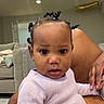 Honey joined the competition — help win amazing prizes! baby, child, infant, portrait, sitting, indoors, living_room, adult, lap, sweater, pink_clothing, hair_buns, curious, wide_eyes, looking_at_camera, couch, chair, home, family, close_up