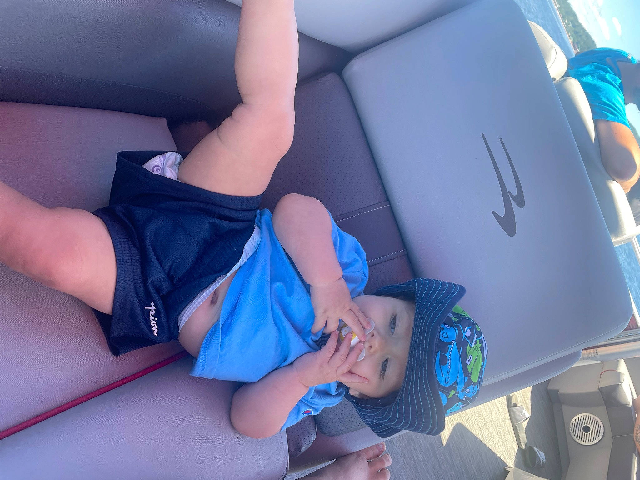 Colton is registered to the contest to win money with this photo: arm, azure, blue, comfort, elbow, electric_blue, finger, fun, hat, headwear, human_body, human_leg, joint, knee, leg, nail, person, shorts, summer, textile